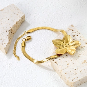 Elegant gold flower petal bracelet with snake chain and adjustable clasp on stone
