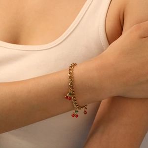 Gold-tone cherry charm bracelet with red and green rhinestones on a thick link chain
