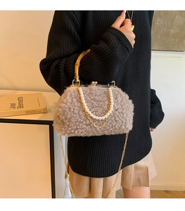 Detail of fuzzy lamb wool bag featuring vintage bamboo handle and pearl chain strap