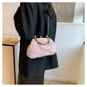 Pink plush faux fur bag detail featuring vintage bamboo handle and elegant pearl chain strap