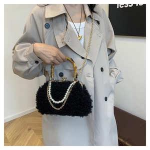 Detail of plush lamb wool shell bag with bamboo handle and golden chain straps