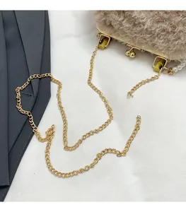 Detail of lamb wool shell bag featuring bamboo handle joint and golden chain strap