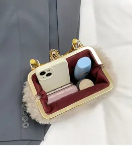 Detailed interior of beige faux shearling shell bag with red lining and golden hardware