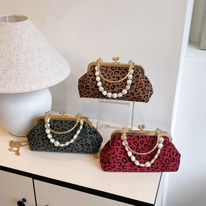 Leopard print shell bags in brown, green, and red with shell bead handles and metal chains