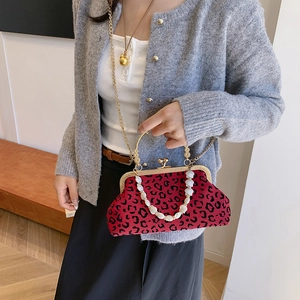 Red and black leopard print shell bag with golden hardware and white beaded handle