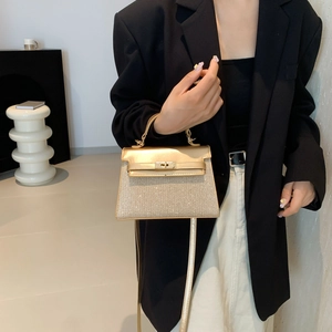 Champagne gold glitter Kelly bag with metallic handle and crossbody strap for women