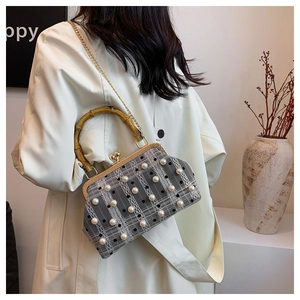 Detail of grey plaid doctor bag with white pearls and a natural bamboo handle
