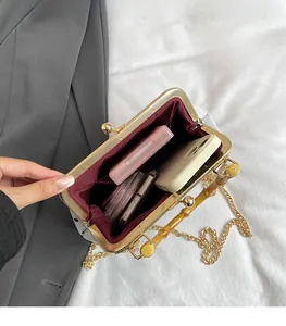 Macro view of the spacious inner compartment and elegant burgundy lining of the bag