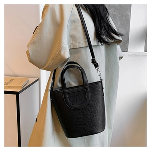 Detail of black lychee grain bucket bag with U-shaped stitching and adjustable strap