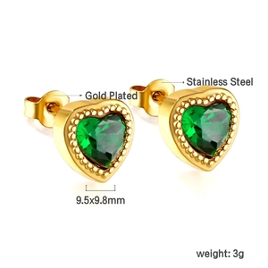 Detail of gold-plated stainless steel stud earrings with green heart-shaped gemstones