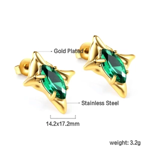 Macro view of gold-plated stainless steel star earrings with green marquise gem