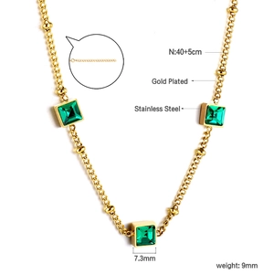 Macro detail of gold-plated necklace with green square gems and 40cm chain size info