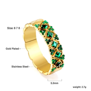 Macro view of gold plated stainless steel ring with emerald green square gemstones
