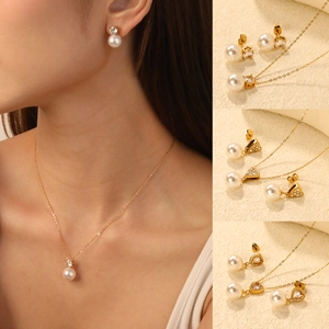 Elegant gold-tone stainless steel jewelry set with white pearls and zircon pendants