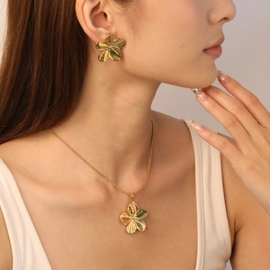 Golden five-petal flower jewelry set with brushed metal texture necklace and earrings