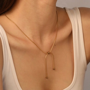 Minimalist 18K gold plated stainless steel adjustable snake chain necklace worn by a model