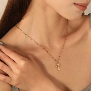 18k gold plated stainless steel cross necklace featuring a textured religious pendant