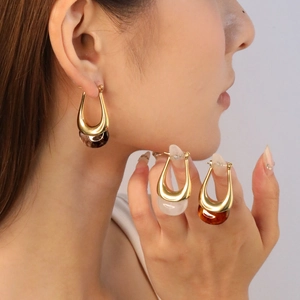 Close-up of French vintage resin drop earrings with gold U-shaped metal loops