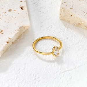 Macro detail of marquise-cut white zircon set on an 18K gold minimalist stainless steel ring