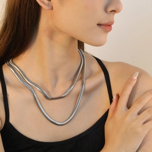 Double-layered silver stainless steel flat snake bone chain necklace on model