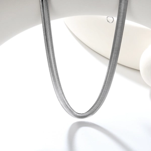 Macro view of polished silver stainless steel herringbone flat snake chain necklace