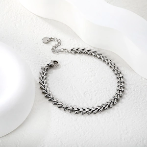 Detail of silver stainless steel herringbone chain with lobster clasp and extension link
