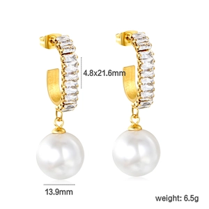 Detail view of 18k gold earrings with square zirconias and 13.9mm white pearl drops