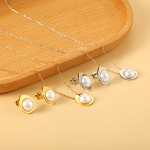 Elegant gold and silver teardrop pearl jewelry set including necklaces and stud earrings
