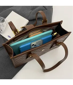Interior view of brown checkered tote bag showing large storage capacity and inner pockets