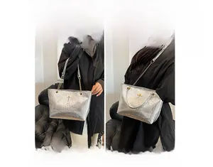 Detail view of silver crocodile texture tote bag with chain strap and metallic finish
