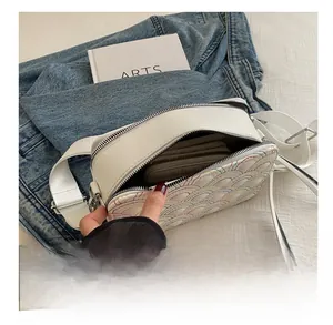 Interior view showing the large capacity of the white bag with colorful stitching