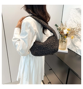 Hobo shoulder bag with 3D floral quilting and puffy cloud texture shown on a model