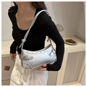 Silver retro baguette bag with metallic rivets shown as a stylish underarm shoulder bag
