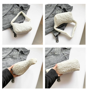 Detailed close-up of white quilted handbag featuring 3D floral texture and spacious interior