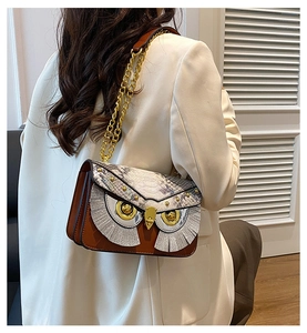 Mannequin portant un sac à bandoulière chouette marron avec motif serpent et chaîne