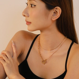 Double-layer 18K gold-plated stainless steel necklace with heart OT clasp on model