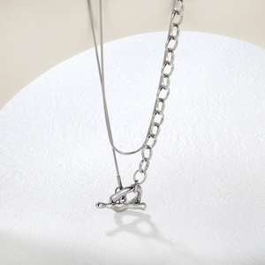 Detail of silver double-layered chain necklace with snake links and toggle OT clasp closure