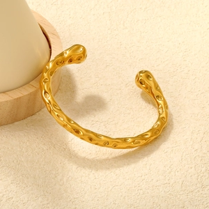 Polished 18K gold plated stainless steel open bangle with unique hammered texture design