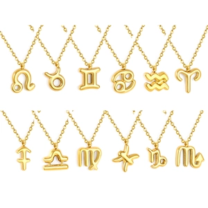 Set of twelve 18k gold plated stainless steel zodiac pendant necklaces on white backdrop