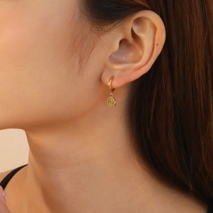 Polished 18K gold plated stainless steel spiral hoop earrings for women on model