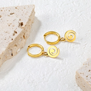 Retro 18k gold stainless steel spiral hoop earrings displayed on white stone textures