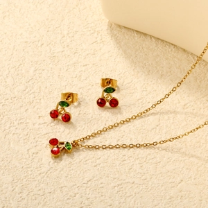 Golden cherry necklace and earrings jewelry set with red and green crystal pendants