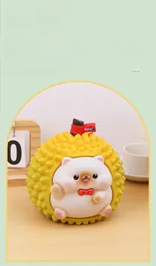 Close-up of durian-shaped hedgehog money box with red bow and Suki flag detail