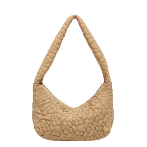 Quilted apricot hued shoulder bag with floral embroidery and puffy texture design