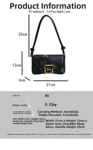 Detail showing printed pattern with golden hardware on black faux leather handbag