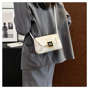 Detail of a cream crossbody bag with geometric prints and iconic metal square buckle