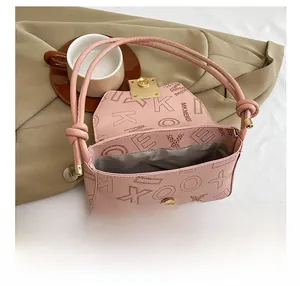Internal view of pink leather shoulder bag with printed monogram and metal magnetic closure