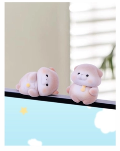 Close-up of cute flocked animal monitor sitters with soft pink tones and tiny bell detail