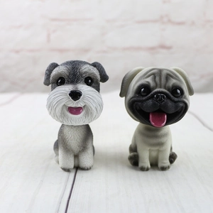 Nodding dog car dashboard ornaments including a Schnauzer and Pug with hair texture detail