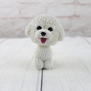 Detailed macro view of white Bichon dog ornament showing realistic resin fur texture